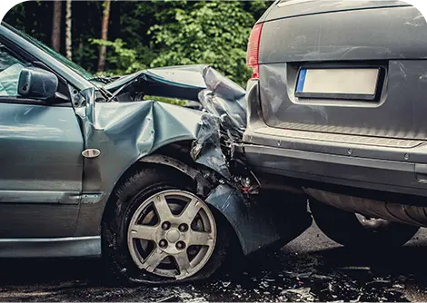 A close-up of a damaged sedan crumpled against the rear of a sports utility vehicle, illustrating the aftermath of a car accident.